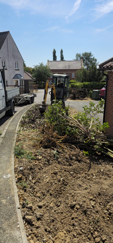 Mini digger clearing a front garden ready for landscaping