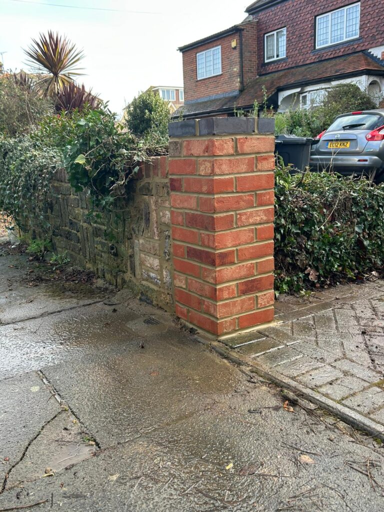Brick pillar rebuilt after storm damage