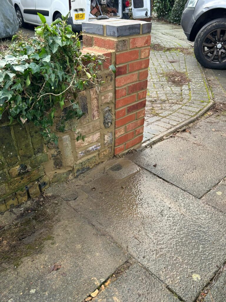 Brick pillar rebuilt after storm damage
