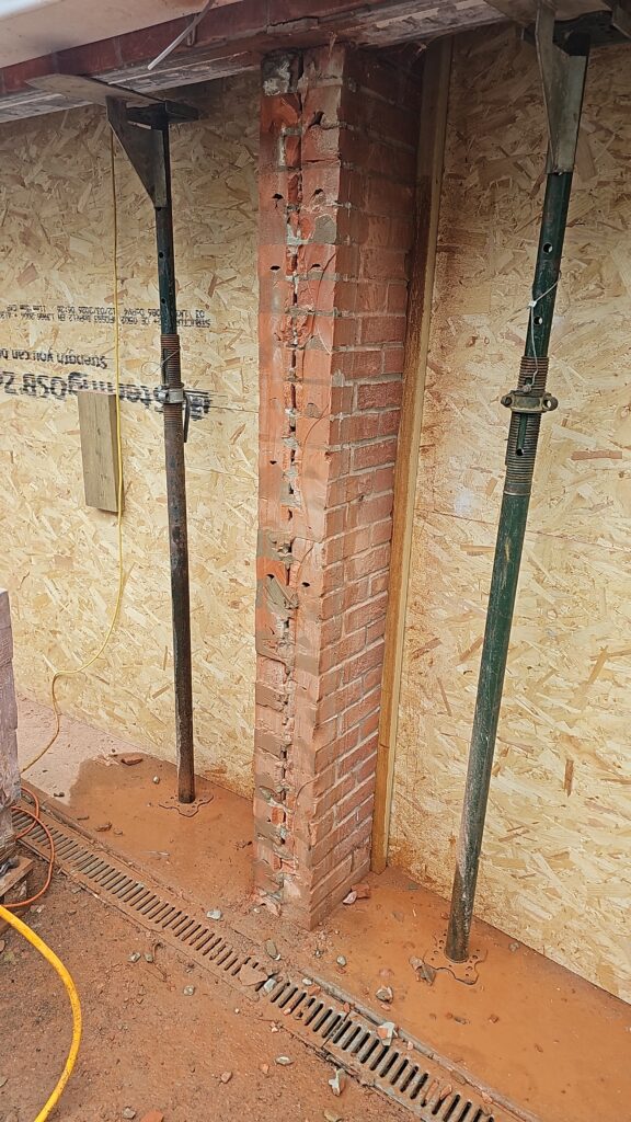 Brickwork and steel prop during a garage conversion