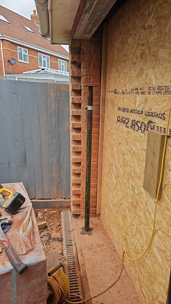 Brickwork and steel prop during a garage conversion