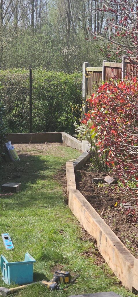 Oak sleeper edging around a garden lawn